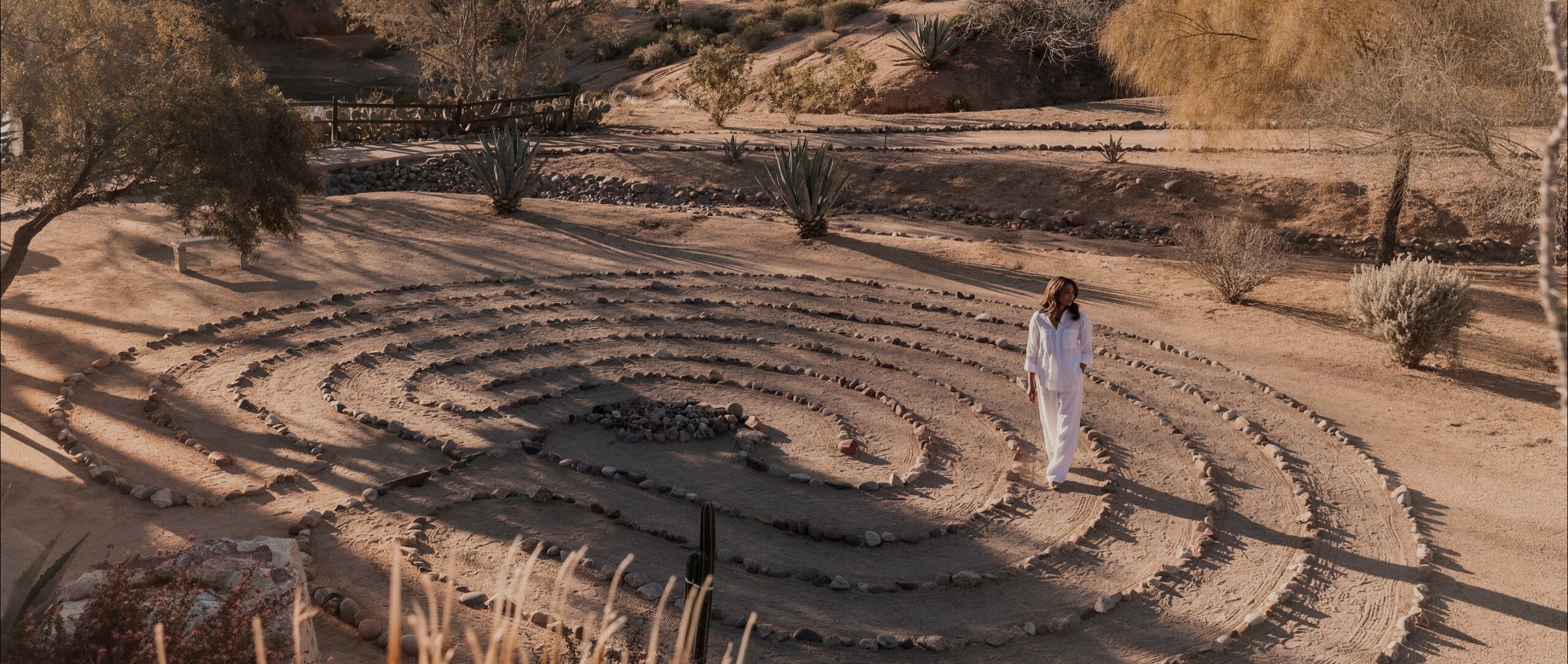 A person walking a stone labyrinth laid out in the desert at CIVANA Carefree