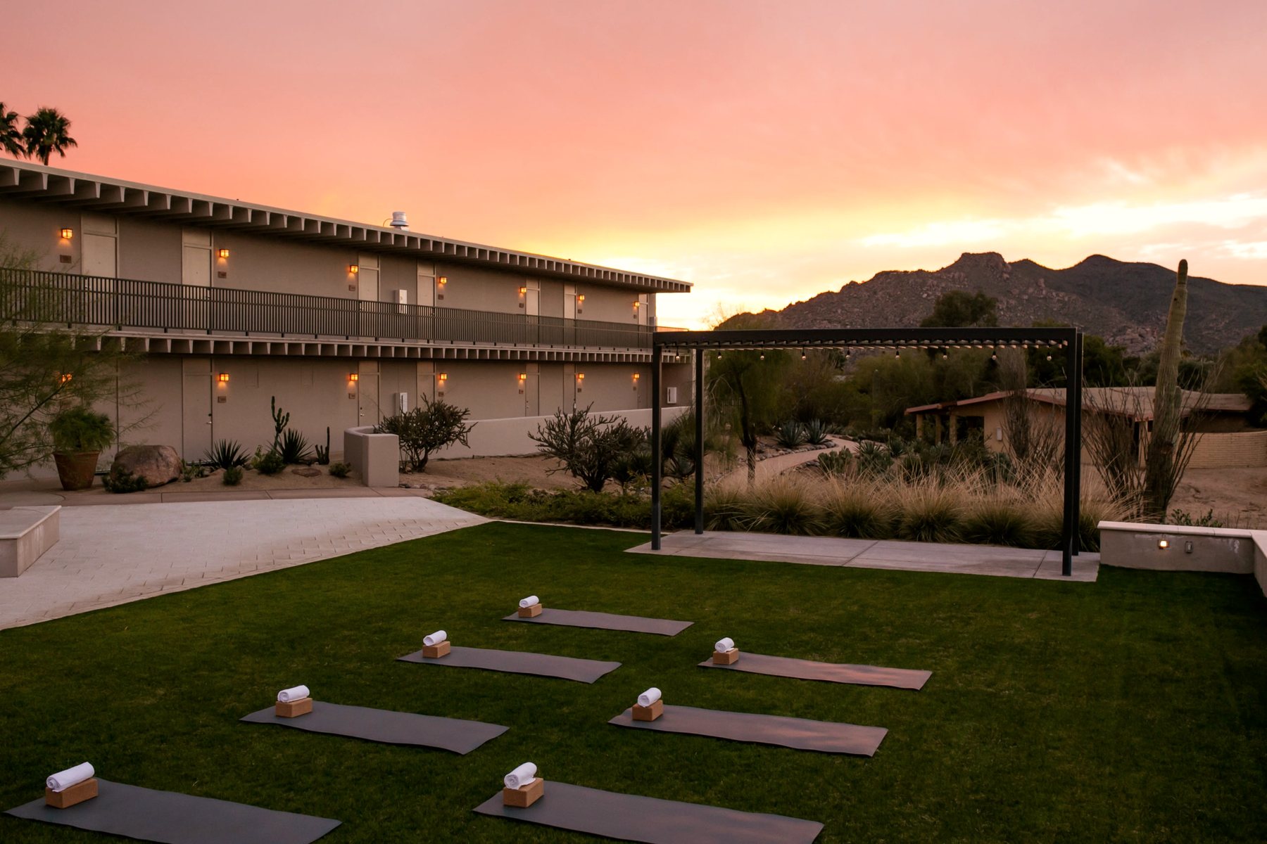 The lawn at CIVANA Carefree at sunset, the resort and the desert mountains behind